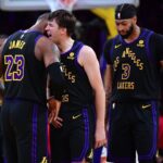 Dec 5, 2023; Los Angeles, California, USA; Los Angeles Lakers guard Austin Reaves (15) reacts after scoring three point basket against the Phoenix Suns with forward LeBron James (23) and forward Anthony Davis (3) during the second half of the In Season Tournament quarterfinal at Crypto.com Arena. Mandatory Credit: Gary A. Vasquez-USA TODAY Sports