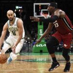 Apr 21, 2024; Boston, Massachusetts, USA; Boston Celtics guard Derrick White (9) controls the ball while Miami Heat center Bam Adebayo (13) defends during the second half in game one of the first round for the 2024 NBA playoffs at TD Garden. Mandatory Credit: Bob DeChiara-USA TODAY Sports