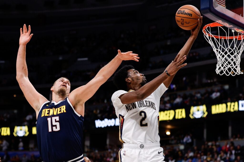 Oct 29, 2025; Denver, Colorado, USA; New Orleans Pelicans forward Herb Jones (2) drives to the basket against Denver Nuggets center Nikola Jokic (15) in the first quarter at Ball Arena. Mandatory Credit: Isaiah J. Downing-Imagn Images
